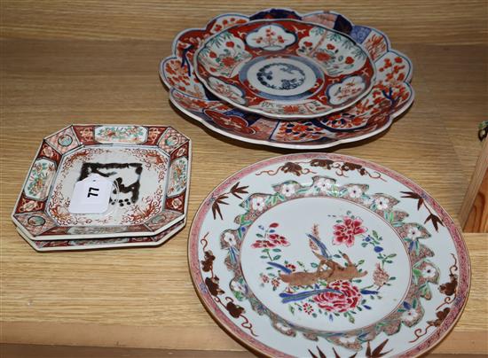 Four Japanese Imari dishes and an 18th century Chinese famille rose plate